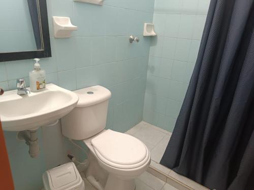 a bathroom with a toilet and a sink and a shower at Tamarindo in Santa Marta