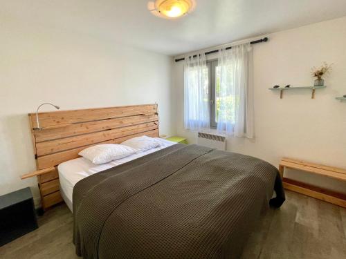 une chambre avec un grand lit et une fenêtre dans l'établissement Maison Confortable près de la Plage, Terrasse et Équipements Modernes, Calme - Brétignolles-sur-Mer - FR-1-231-61, à Bretignolles-sur-Mer