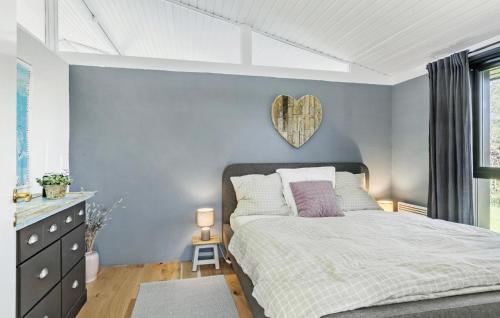 a bedroom with a bed with a heart plaque on the wall at Stunning Home In Gilleleje With Wifi in Gilleleje