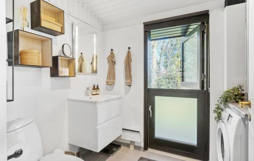 a bathroom with a sink and a door at Stunning Home In Gilleleje With Wifi in Gilleleje