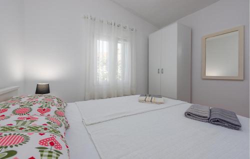 a white bedroom with a large white bed with a blanket at 1 Bedroom Stunning Home In Potocnica in Borovići
