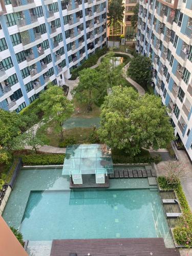 an overhead view of a swimming pool in a building at Centrio Condominiums Top Floor with Pool and Garden view in Ban Na Khua
