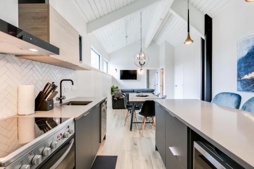 an open kitchen with a counter and a dining room at Complexe La Voûte by Gestion ELITE in Laval