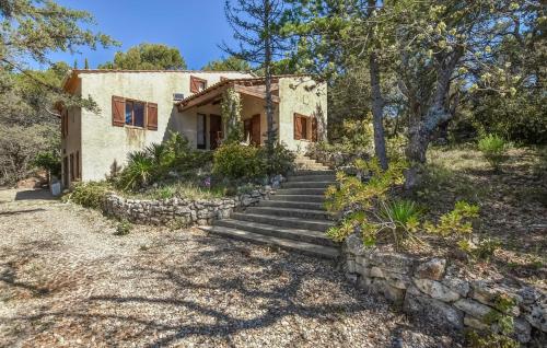 a stone house with stairs leading up to a house at Beautiful Home In Apt in Apt