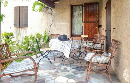 a patio with chairs and a table with a hat on it at Beautiful Home In Apt in Apt