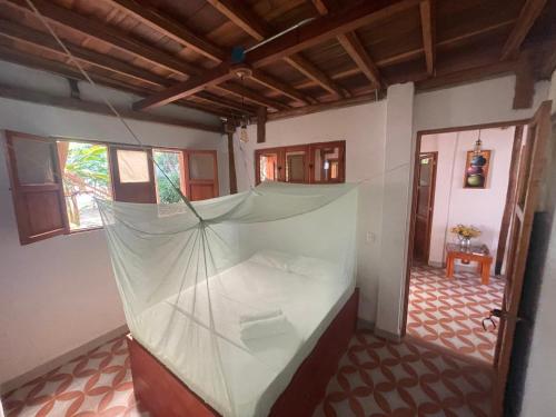 a room with a bed with a net in it at PALUM Prívate Room share bathroom in Palomino
