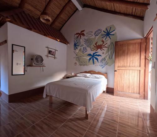 A bed or beds in a room at Casa H Rinconcito Mazunte