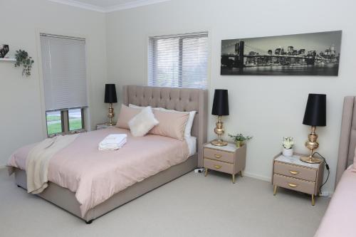 a bedroom with a large bed with two night stands at Spacious Villa 7BRM 5-bathroom House Point Cook Double Storey in Point Cook