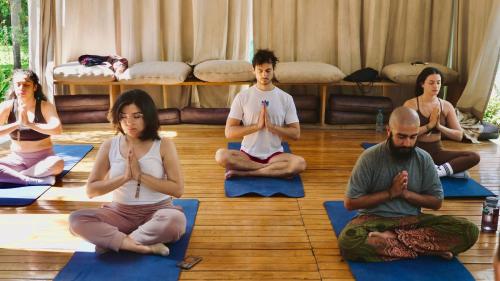a group of people sitting in a room doing yoga at qema Arequipa in Arequipa