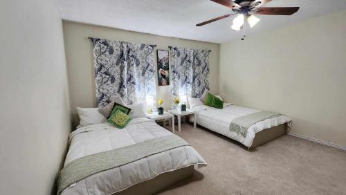 a bedroom with two beds and a ceiling fan at 50 scarborough golf club rd in Toronto
