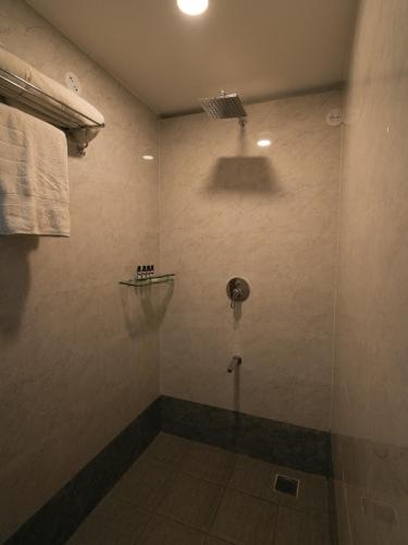 a shower with a glass door in a bathroom at MGM Whispering Wind's Yelagiri in Yelagiri