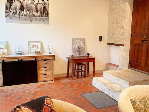a living room with a dresser and a table with horses on the wall at Charmant gîte à Pontlevoy avec cour privée, vélos, terrasse et proche des châteaux et commerces - FR-1-491-353 in Pontlevoy