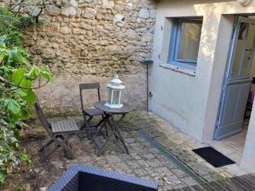 a table and two chairs in front of a building at Charmant gîte à Pontlevoy avec cour privée, vélos, terrasse et proche des châteaux et commerces - FR-1-491-353 in Pontlevoy
