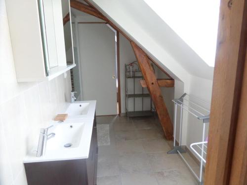 ein Badezimmer mit einem weißen Waschbecken und einer Treppe in der Unterkunft Gîte Sambin, 4 pièces, 6 personnes - FR-1-491-342 in Sambin