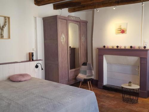 ein Schlafzimmer mit einem Bett, einer Kommode und einem Kamin in der Unterkunft Gîte Pontlevoy, 4 pièces, 4 personnes - FR-1-491-349 in Pontlevoy