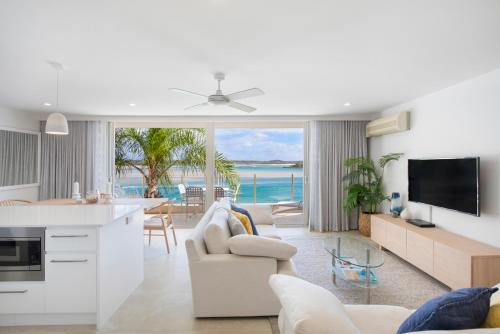 a kitchen and living room with a view of the ocean at Noosa Harbour Resort in Noosa Heads