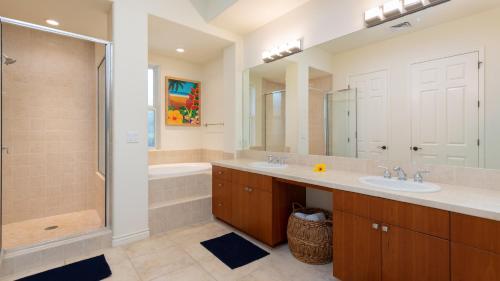 a bathroom with two sinks and a shower and a tub at MAUNA KEA SUNSETS Gorgeous 2BR Kumulani Condo with Ocean Sunset View in Hapuna Beach