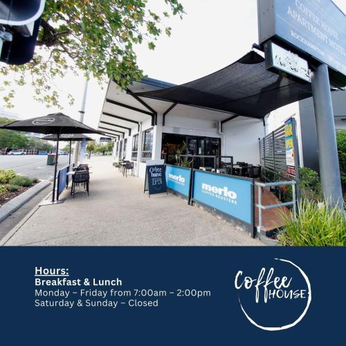a store with an umbrella and tables and chairs at Coffee House Apartment Motel in Rockhampton