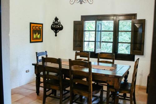 - une salle à manger avec une table et des chaises en bois dans l'établissement Finca Ana Isabel, 