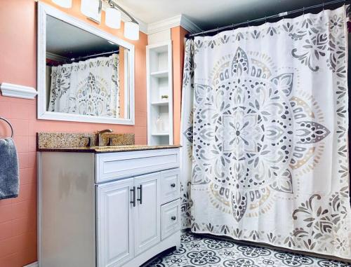 a bathroom with a white shower curtain and a sink at All Seasons Cottage - Game Room - Firepit By Zen Living Short Term Rental in Luray