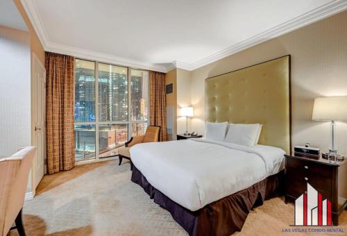 a bedroom with a large bed and a large window at MGM Signature-08-801 1Br2Ba F1 Strip View Balcony in Las Vegas