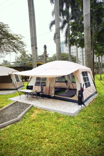 a tent is set up in a field of grass at HARRIS Hotel Sentul City Bogor in Bogor
