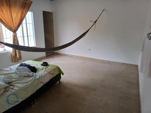 a bedroom with a bed with a net on the wall at HABITACION PARA 2 PERSONAS COMODA in Valledupar