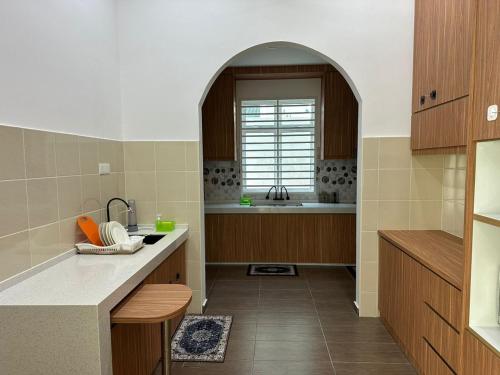 a kitchen with a sink and a window in it at Live Well Homestay Senawang in Seremban