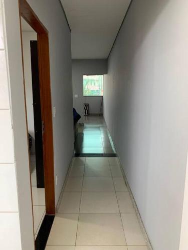 an empty hallway of a room with a white wall at Apto c Garagem próx Petrobrás e Fiat 194 2. in Betim