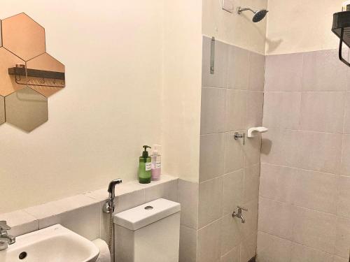 a bathroom with a toilet and a sink and a shower at Condo Glamping at Vinia in Manila