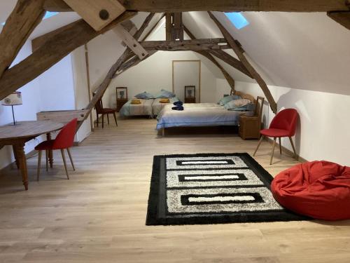 a bedroom with two beds and a rug on the floor at Gîte Villedieu-le-Château, 5 pièces, 10 personnes - FR-1-491-432 in Villedieu-le-Château