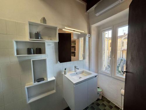 a white bathroom with a sink and a window at Appartement Alata, 3 pièces, 4 personnes - FR-1-61-628 in Alata