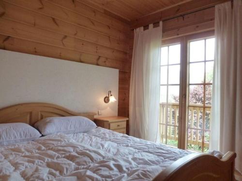 a bedroom with a bed and a large window at Pleasant apartment in Naturns in Naturno