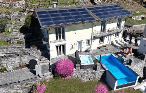an aerial view of a house with a solar roof at Casa Makatea - b44831 in Brione sopra Minusio
