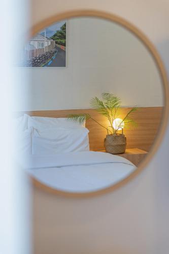 a bedroom with a bed with a mirror at Aank Hotel Daejeon Yongjeon 2nd in Daejeon