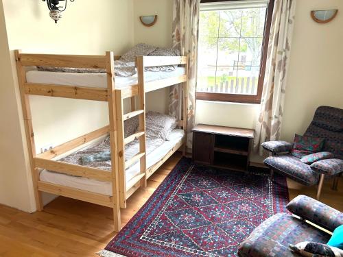 a room with two bunk beds and a window at Csuka Vendégház in Kisbodak