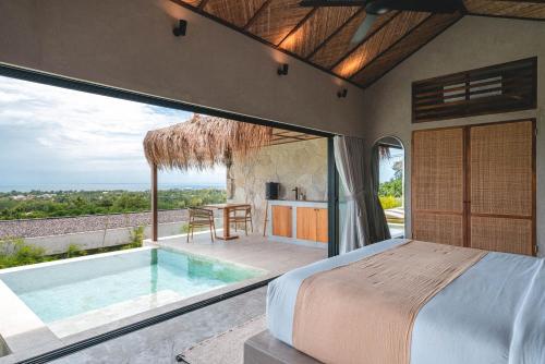 a bedroom with a bed and a swimming pool at SIVANA, Hotel Boutique with ocean or garden views - Adults only in Uluwatu