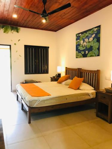 a bedroom with a large bed in a room at Jim's Beach Villas in Hikkaduwa