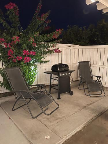 two chairs and a table on a patio at night at The Coachella Gem weekly discounts in Coachella