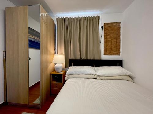 a bedroom with a large bed and a mirror at ChillOut in Cheung Chau in Hong Kong