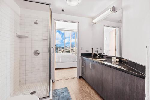 a bathroom with a shower and a sink at Beautiful 2 BR Sky View Apartment in Los Angeles