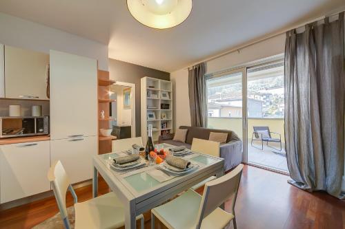 a kitchen and living room with a table and chairs at Suite 22 - Happy Rentals in Riva del Garda