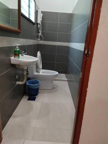 a bathroom with a sink and a toilet at The Bird's Nest Holiday Villa Port Dickson in Port Dickson