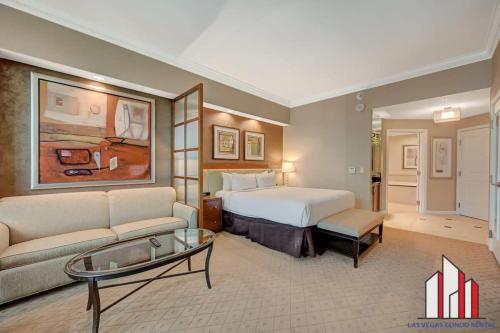 a hotel room with a bed and a couch at MGM Signature-34-803 F1 Track & Strip View Studio in Las Vegas