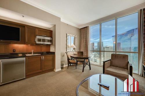 a living room with a kitchen and a dining room at MGM Signature-34-803 F1 Track & Strip View Studio in Las Vegas