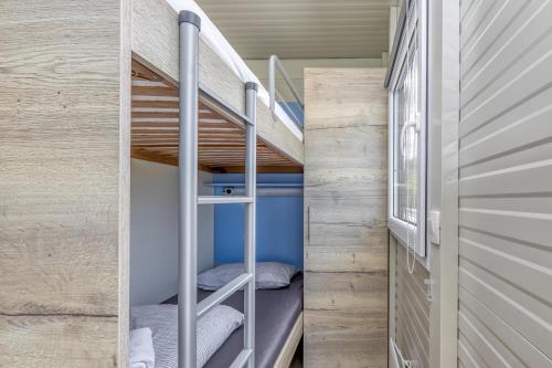 a small room with bunk beds in a tiny house at Rooftop Home With Whirlpool & Sauna in Trebnje