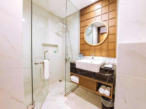 a bathroom with a sink and a shower at Pearl Nusa Dua Suite in Nusa Dua