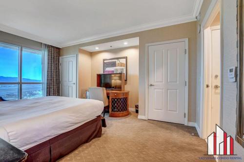 a bedroom with a large bed and a television at MGM Signature-37-814 1Br 2Ba F1 Pits View Balcony in Las Vegas