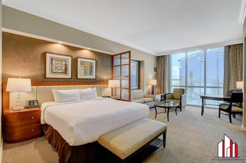 a large hotel room with a bed and a desk at MGM Signature-34-819 F1 Track & Strip View Studio in Las Vegas