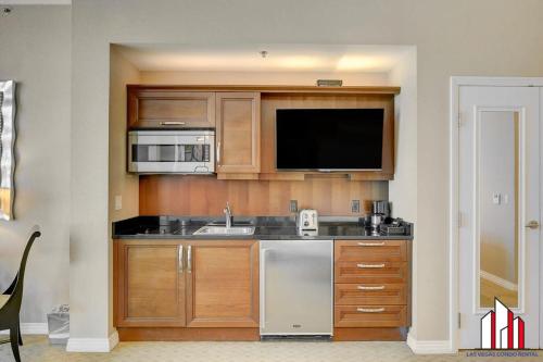 a kitchen with a sink and a microwave at MGM Signature-34-819 F1 Track & Strip View Studio in Las Vegas